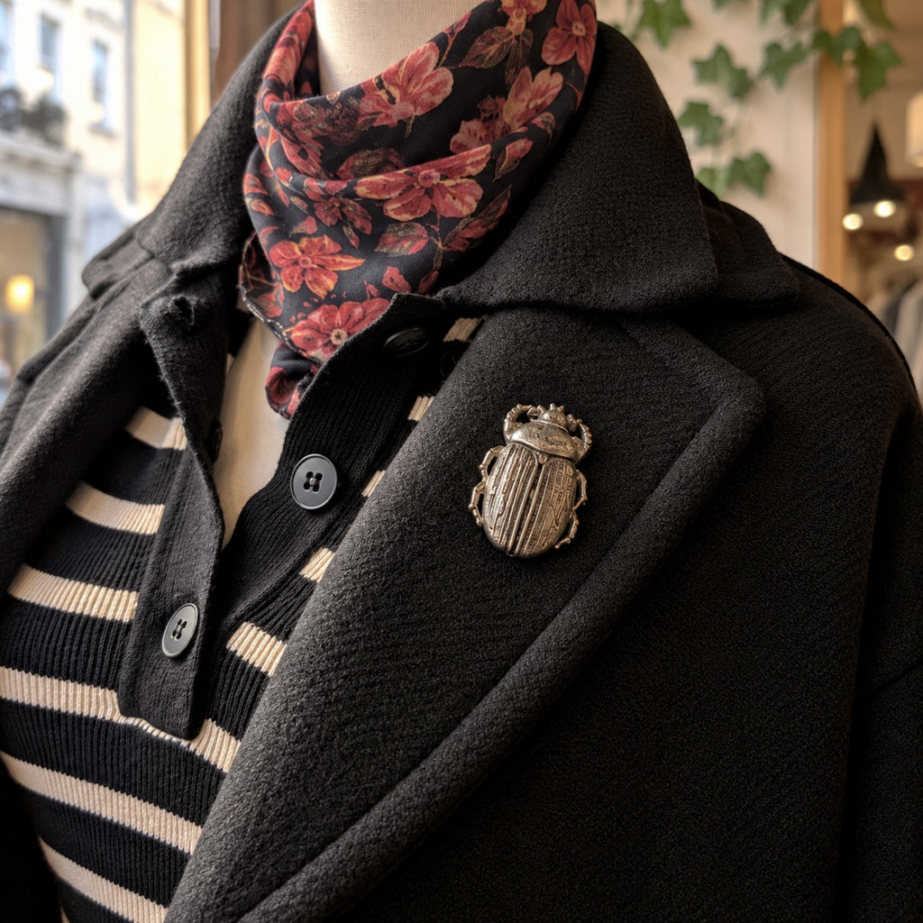 Broche scarabée Création MOUNS portée sur un manteau noir